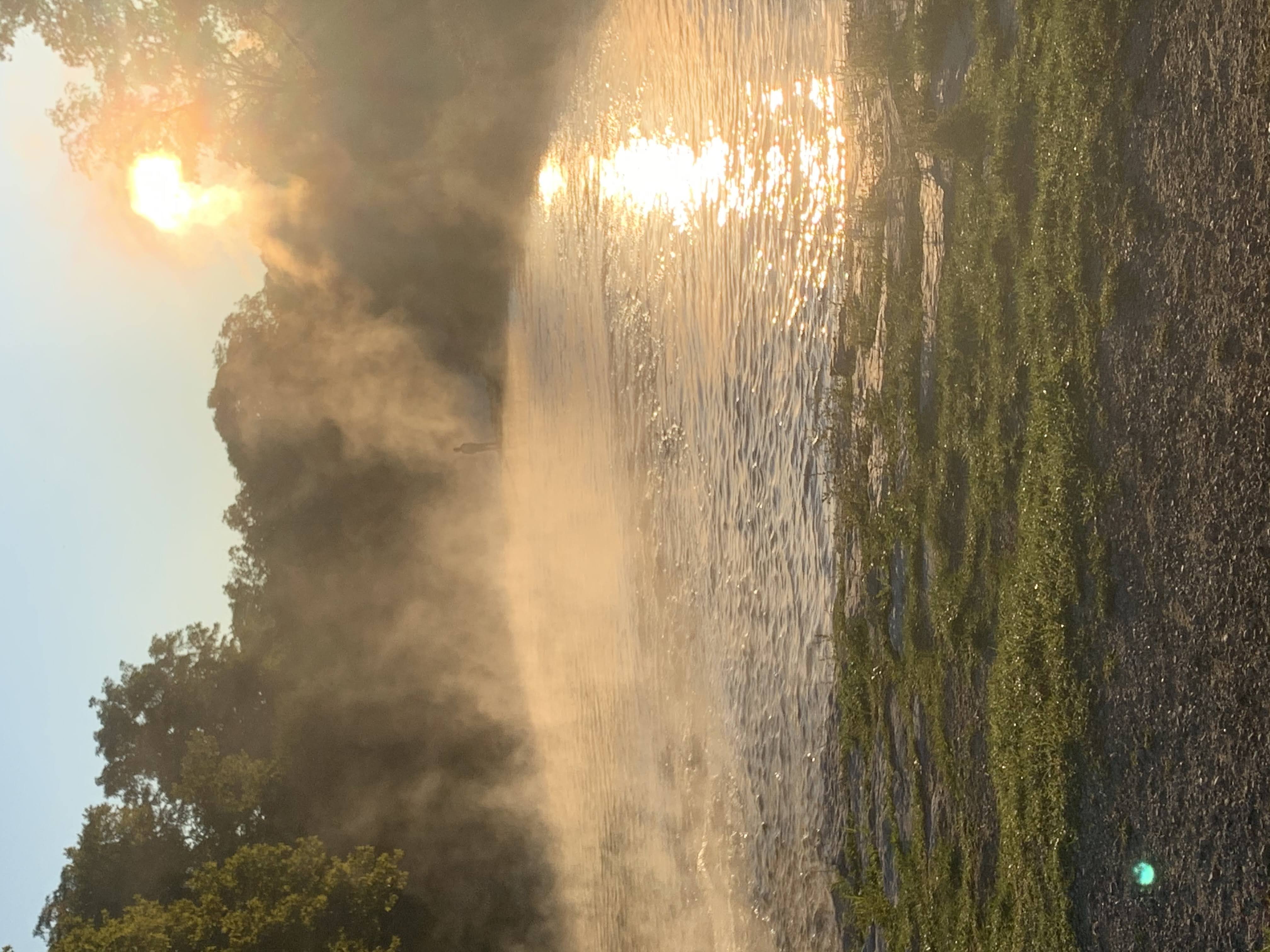 the mist rising over a river in the morning